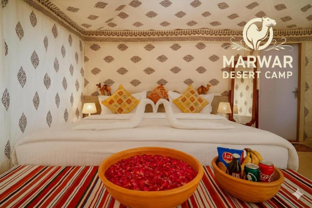 a bedroom with a bed with a bowl of red peppers at Marwar Desert Camp Sam Jaisalmer in Sām