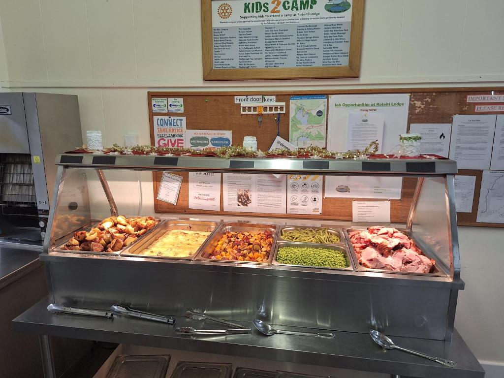 a display case with many different types of food at Rotoiti Lodge in Saint Arnaud