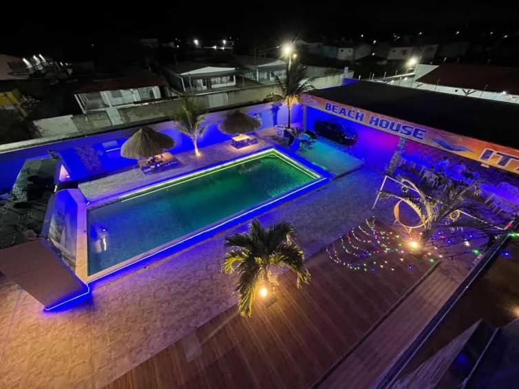 an overhead view of a swimming pool at night at @BeachHouseItamaraca in Itamaracá