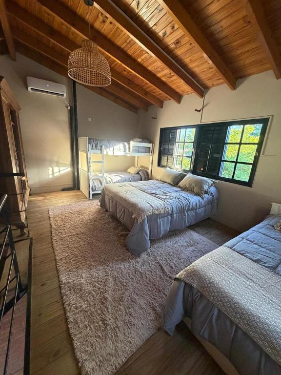 a bedroom with two beds and a large rug at Loft del centro Saladillo in Saladillo