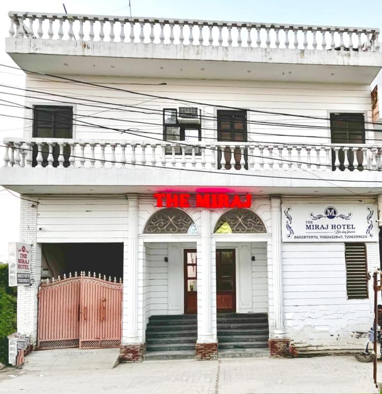 a white building with a sign that reads the nines at The Miraj Hotel in Murthal