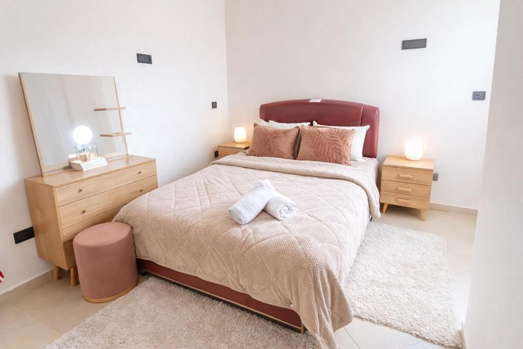 a bedroom with a large bed and two night stands at Spacious Family-Friendly Apartment in Temara