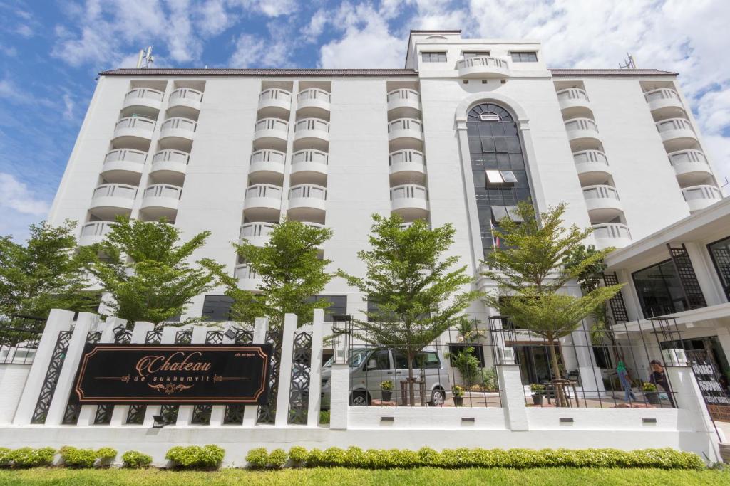 a white building with a sign in front of it at Chateau de Sukhumvit in Bangkok