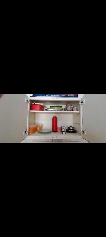 an open refrigerator door with food items on it at Alquileres BH in La Rioja