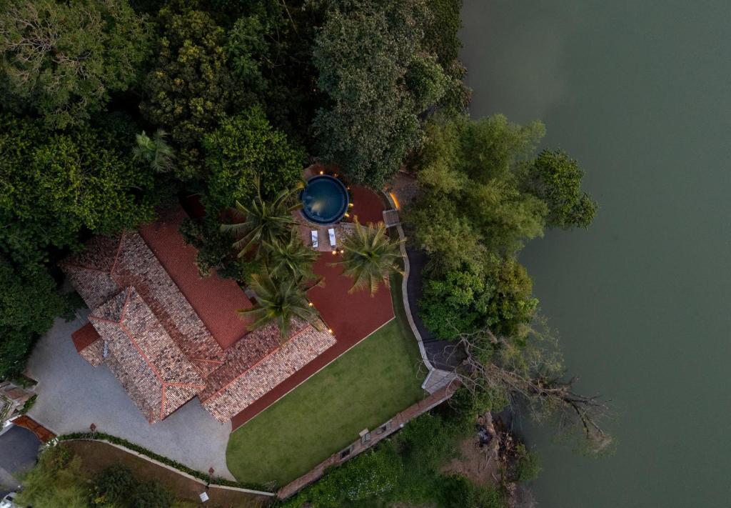 an overhead view of a house with trees and water at Ridee Kandy in Kandy