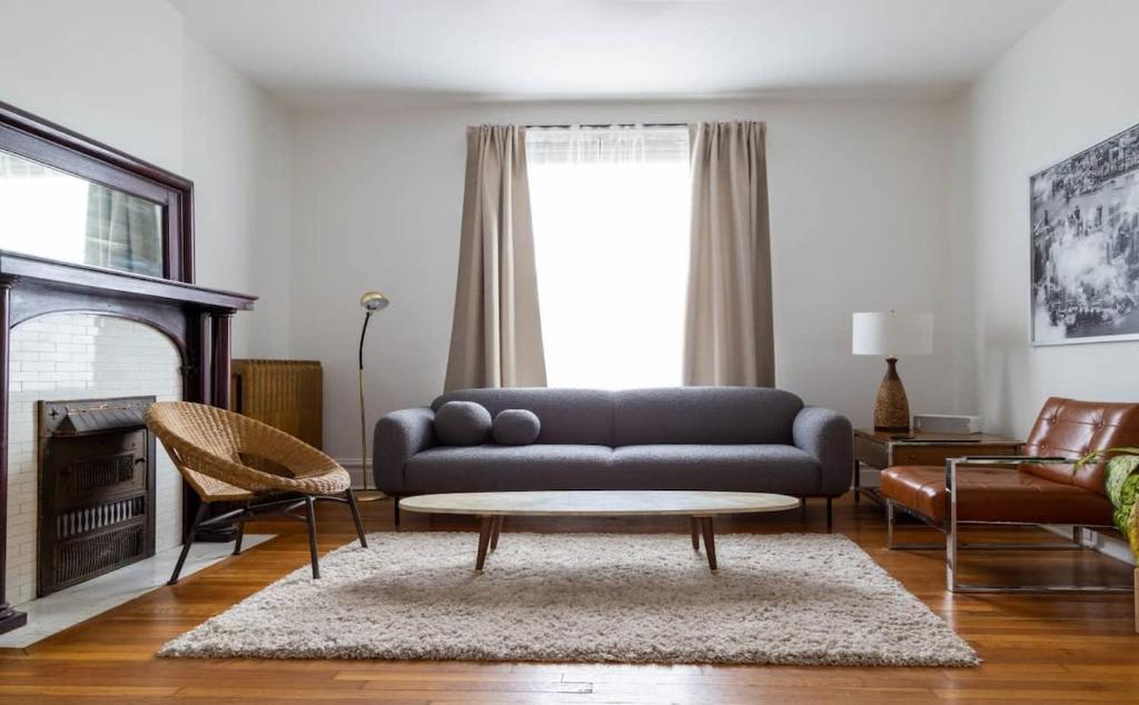 a living room with a couch and a coffee table at Swanky Shaw 2BR with Office ABODEbucks in Tower Grove