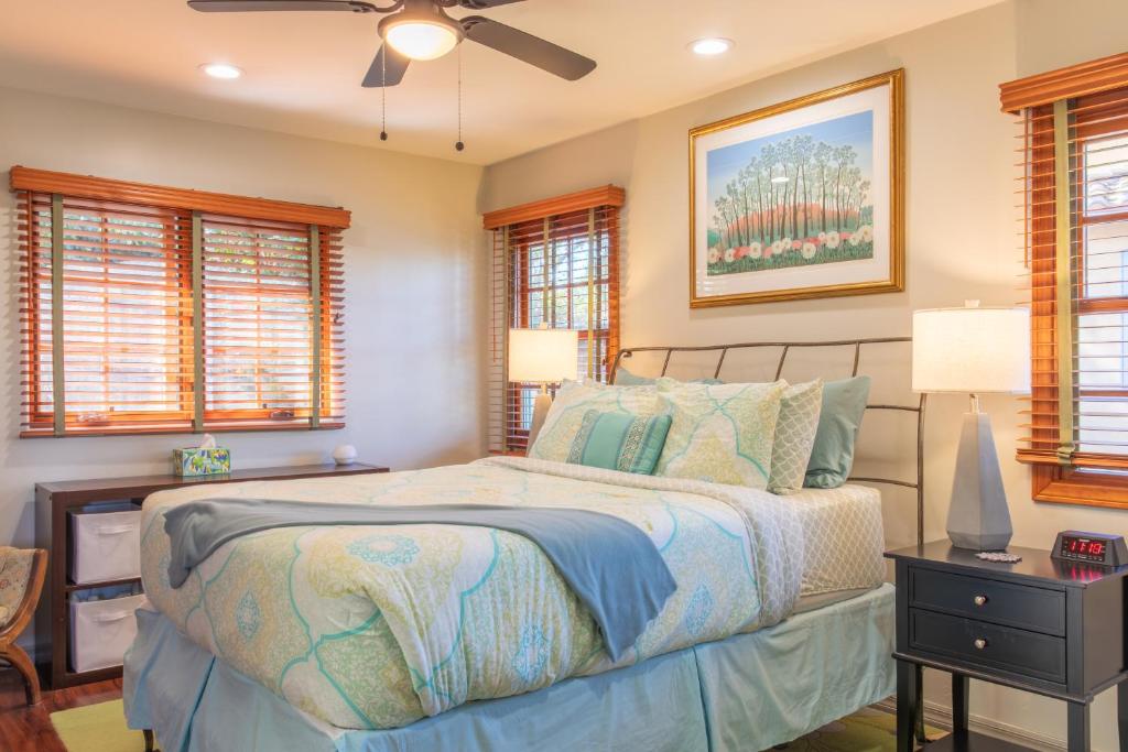 a bedroom with a bed and a ceiling fan at The Little Pumpkin Guest House in San Diego