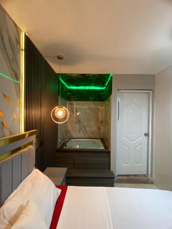 a bedroom with a bed and a green ceiling at Luxury and beautiful studio private jacuzzi in Santo Domingo