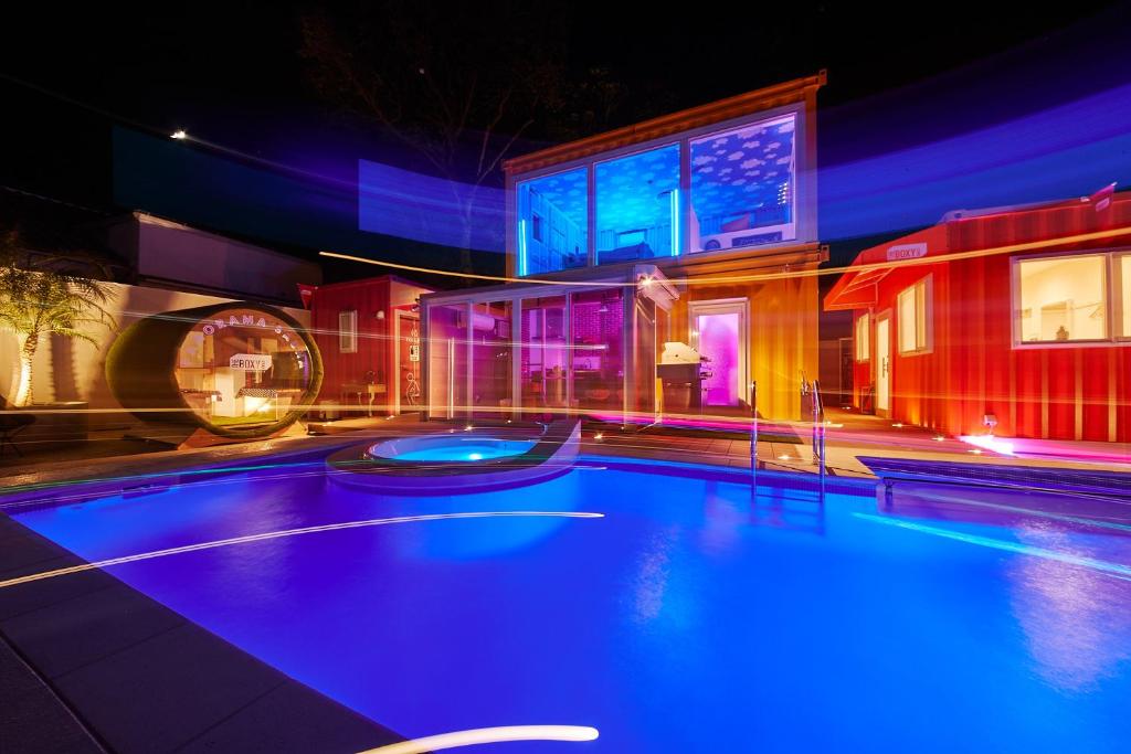 a swimming pool with blue lights in a building at THE BOXY AWAJI in Awaji