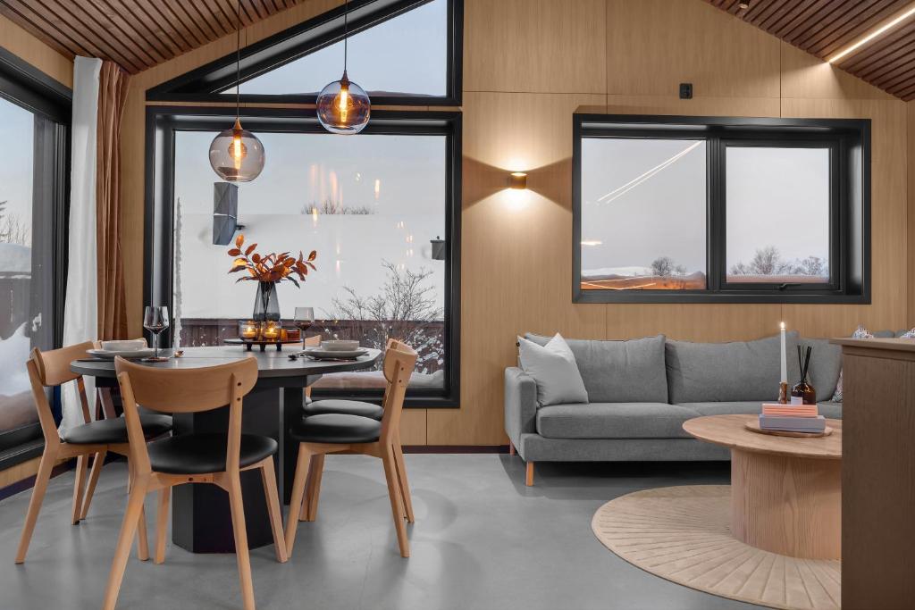 a living room with a table and a couch at Signature Townhouse for Luxury Living Arctic Seasons in Tromsø