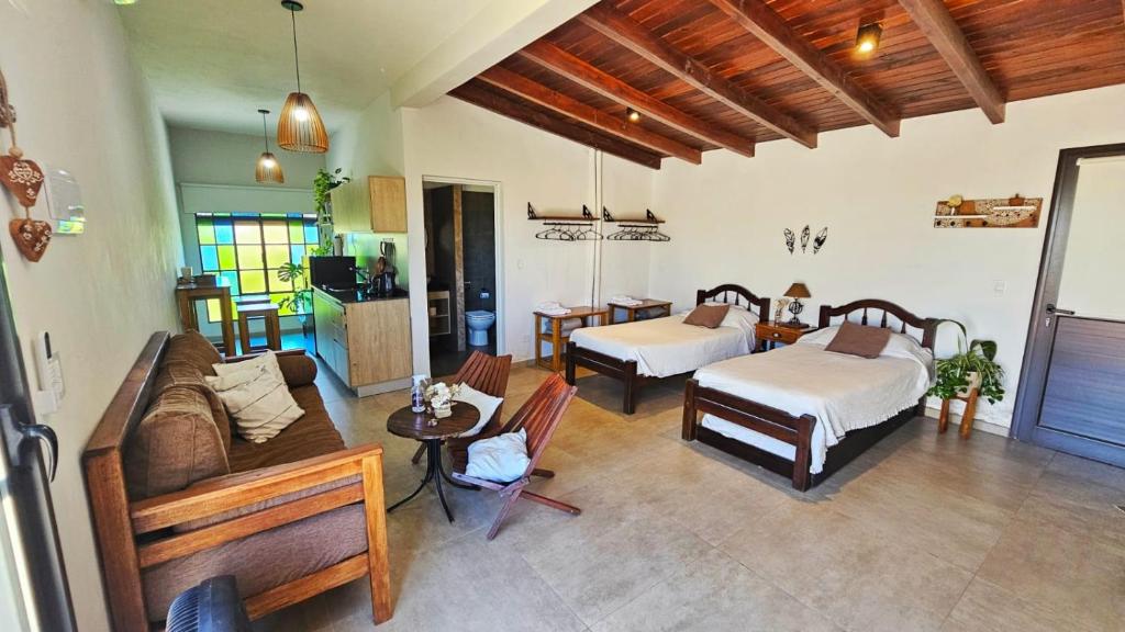 a living room with two beds and a couch at Terrazas al Golf in Alta Gracia