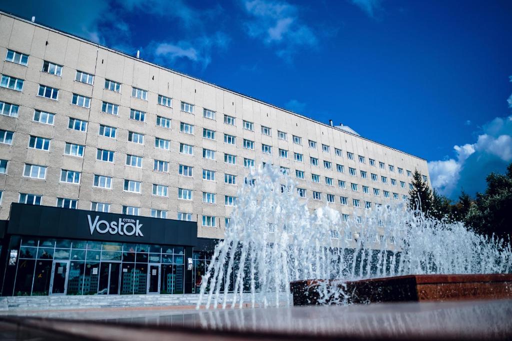 a water fountain in front of a building at Vostok Hotel in Tyumen