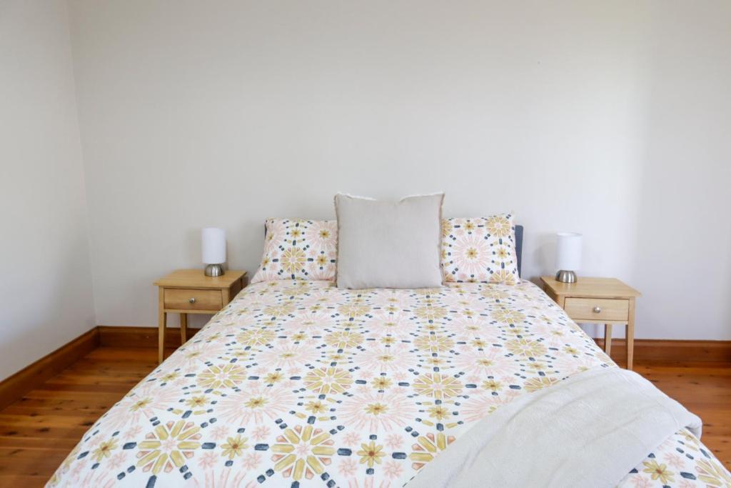 a bedroom with a bed with two night stands at Spacious 3-Bed Home in Central Tenterfield in Tenterfield