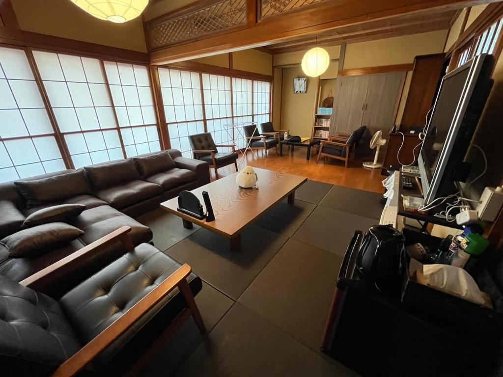 a living room with a couch and a table at ほしのすみか in Nikko