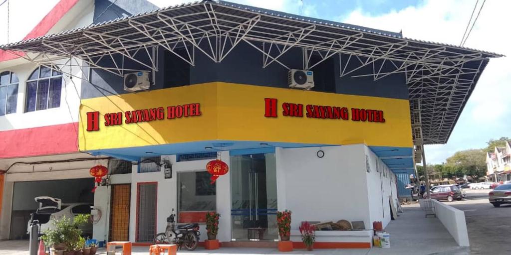 a building with a sign that reads i am burning blood at H Sri Sayang Hotel Sdn Bhd in Skudai