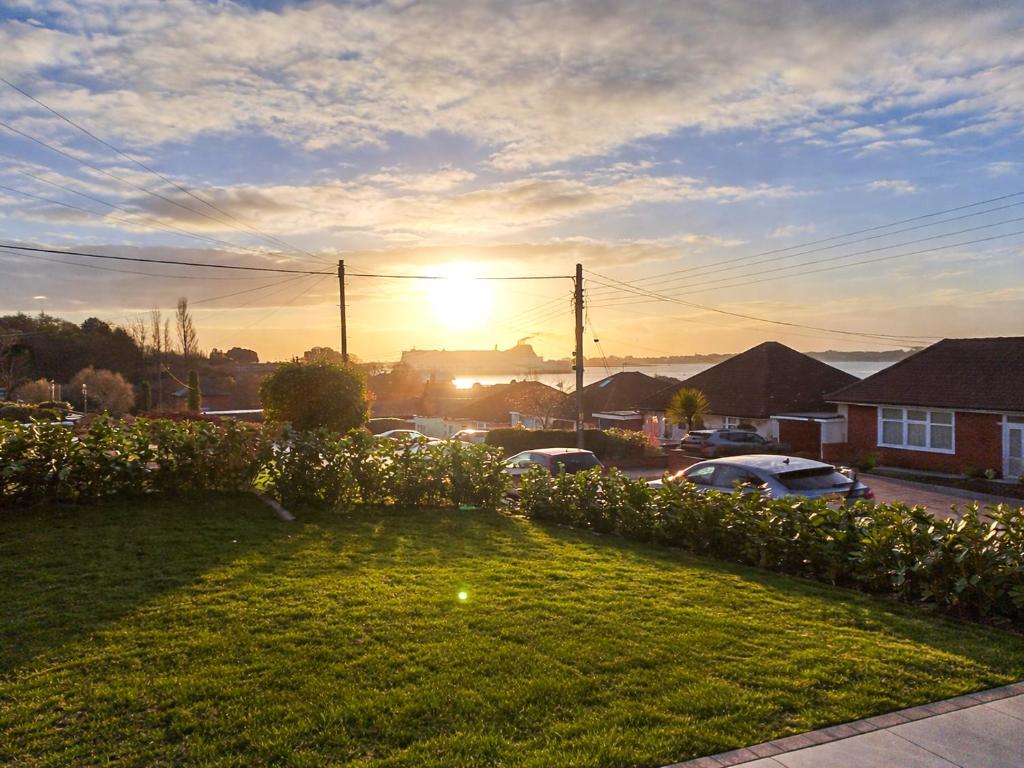 a view of the sunset from a yard with flowers at The Lobster Pot in Shotley Gate