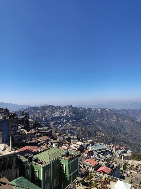 an aerial view of a city with mountains in the background at Mizotel in Āīzawl