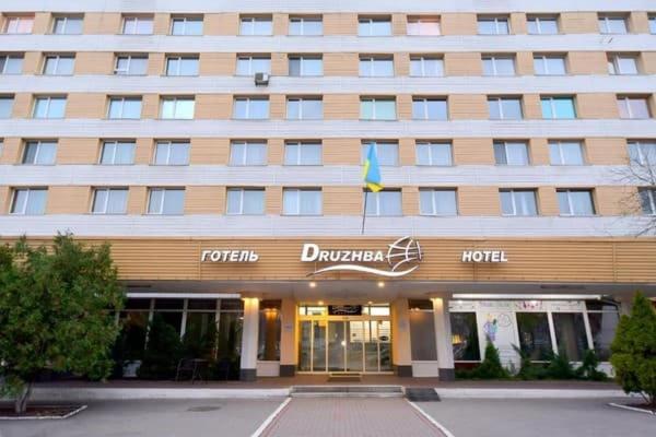 a hotel building with a flag in front of it at Готель Дружба in Kyiv