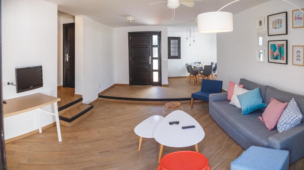 a living room with a couch and a table at Los Cardones Boutique Village in Playa de las Americas