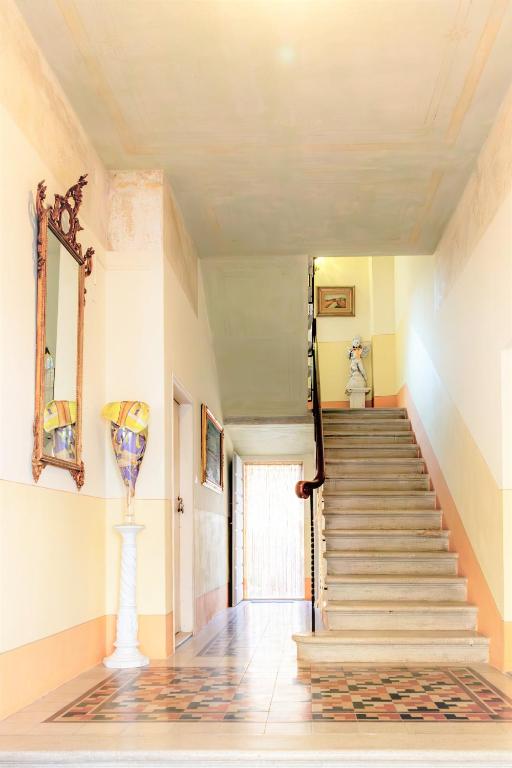 a hallway with stairs and a vase on the wall at Suite900 - Apartment Premium Suite in Arezzo