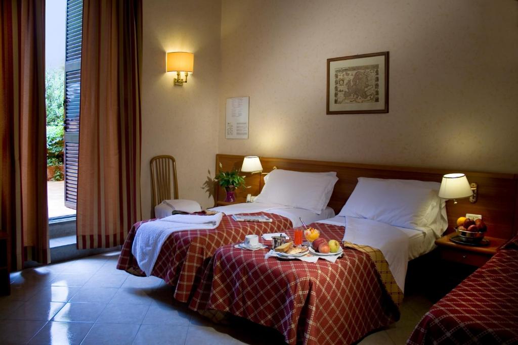 Uma cama ou camas num quarto em Hotel Delle Muse