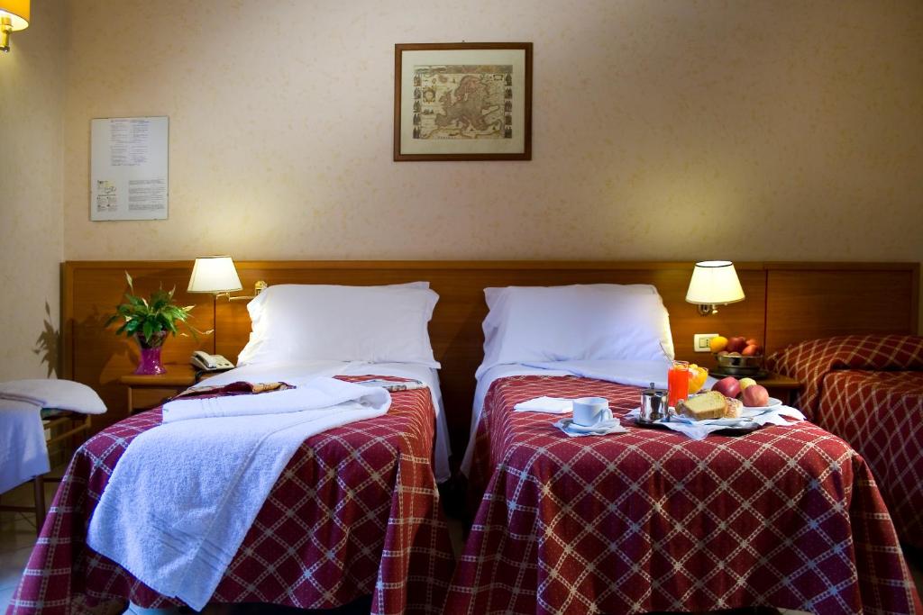 Uma cama ou camas num quarto em Hotel Delle Muse