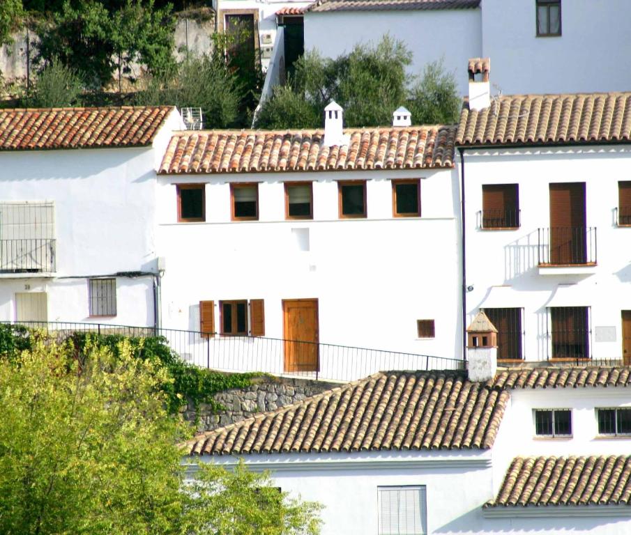 a group of white buildings with tile roofs at Casa Rural El Aljibe in Benamahoma