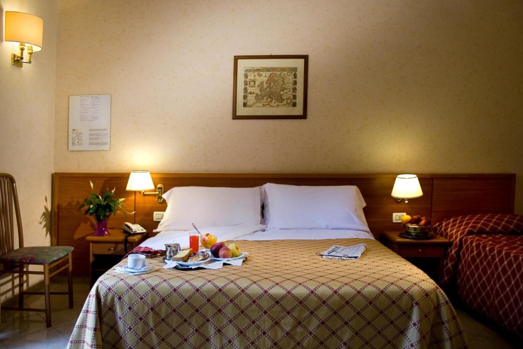 Uma cama ou camas num quarto em Hotel Delle Muse