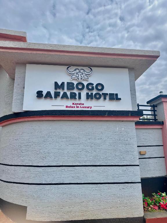 a sign for a moocsa saar hotel on a building at Mbogo Safari Hotel in Karatu
