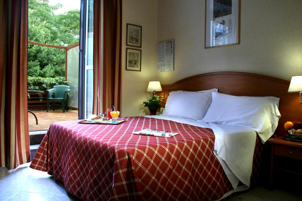 Uma cama ou camas num quarto em Hotel Delle Muse