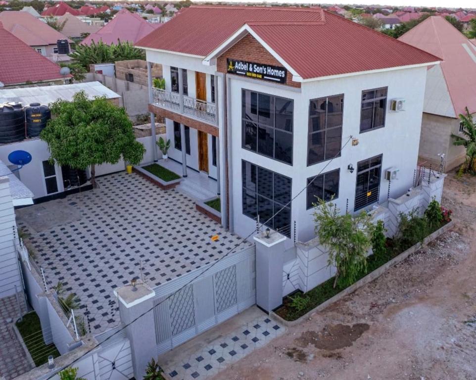 an overhead view of a white house with a red roof at Abdel & sons homes in Dodoma