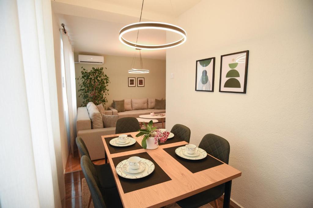 a dining table and chairs in a living room at M&S Central Residence in Bitola
