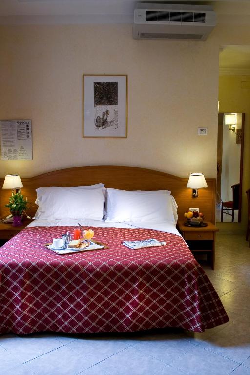 Uma cama ou camas num quarto em Hotel Delle Muse