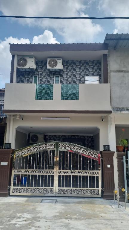 a house with a gate in front of it at SriStar in Kluang