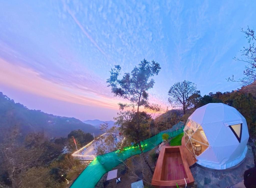a view of a water park at sunset at Glamo home kasauli in Kasauli