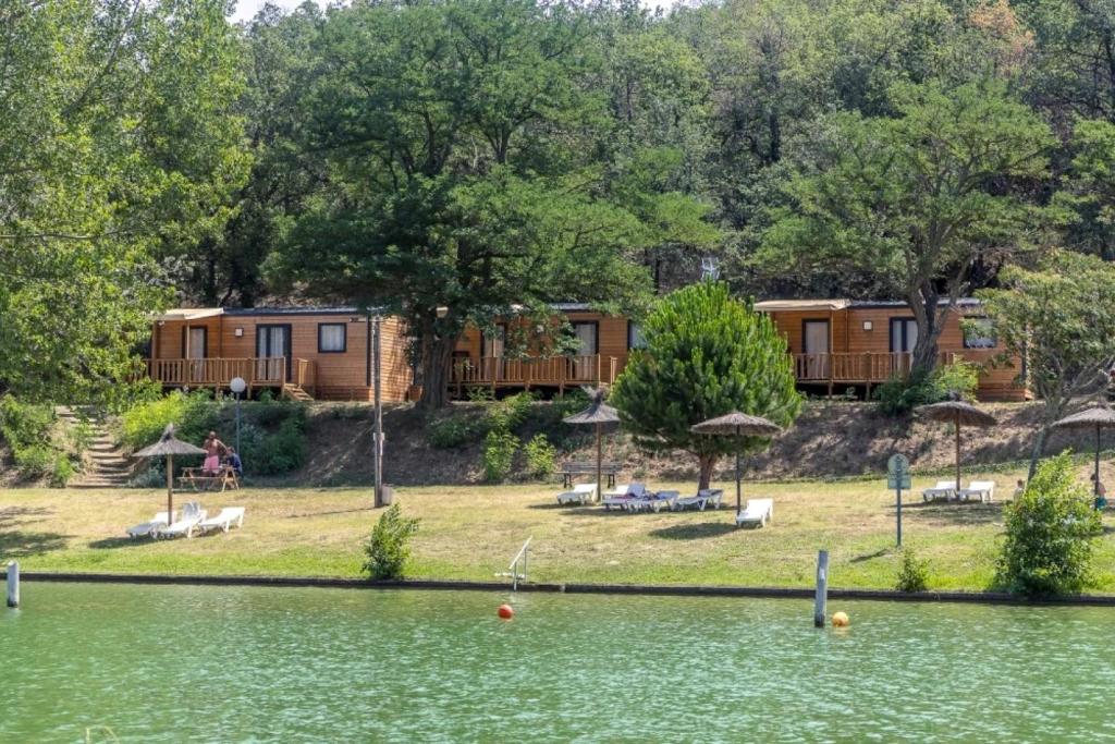 a view of a resort from the water at ZEcamping 3 étoiles animaux acceptés en bord de lac in Vinça