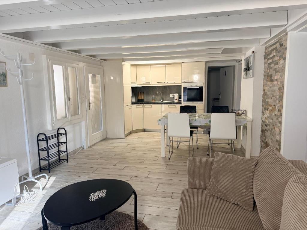 a living room with a couch and a table at Appartment Happy Life - Wimmis - near Spiez-Thun- Interlaken in Wimmis