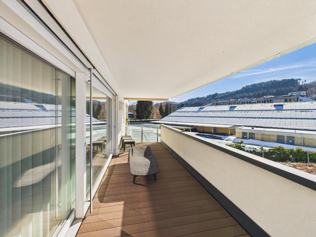 an empty balcony with a chair on a building at LakeSide Suite in Seeboden
