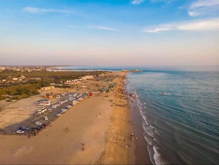 an aerial view of a beach with a crowd of people at HV Beach Resort in Mandvi