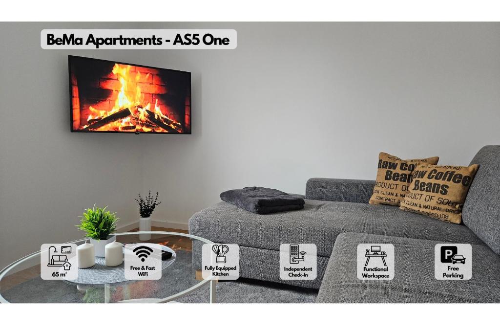 a living room with a couch and a fire on the wall at AS5 One Hallstadt - Großes 3-Zimmer-Apartment - Balkon, Parkplatz & Bahnhofsnah - BeMa Apartments Bamberg in Hallstadt