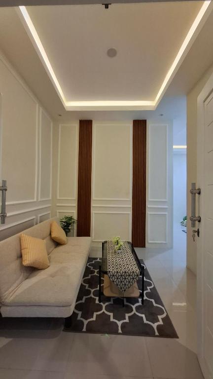 a living room with a couch and a table at Z Guest House in Banyuwangi