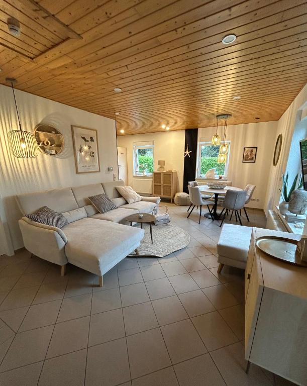 a living room with a couch and a table at ZweiundMeer Bungalow 2 in Wiek auf Rügen