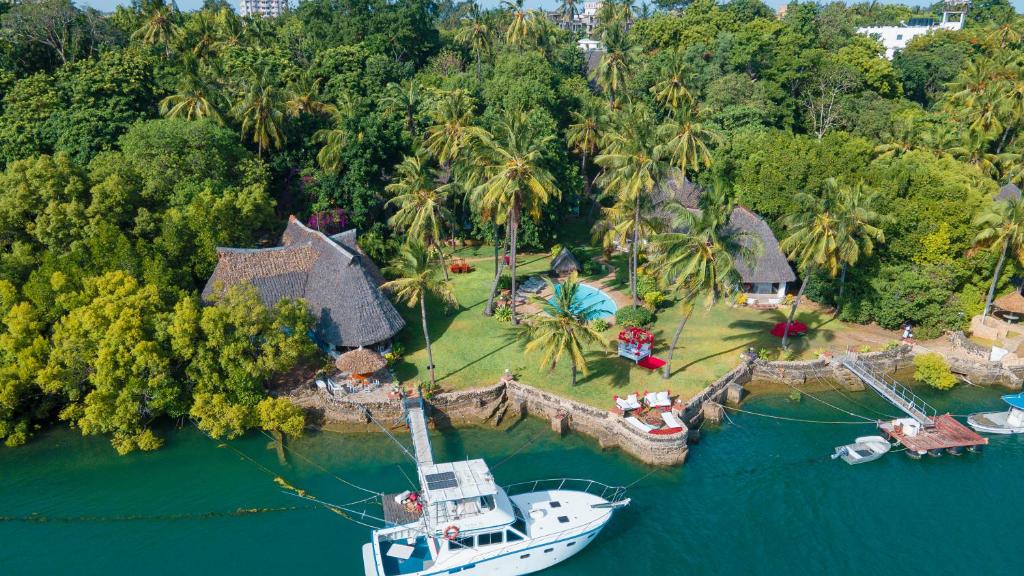 a boat is docked at a house in the water at Horizon Bavaria Villa in Mtwapa