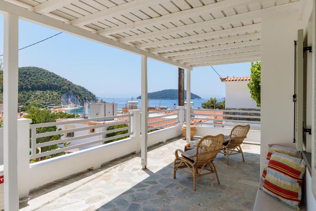 a patio with chairs and a view of the ocean at Iremia Coastal Retreat - Private Sea View Terrace in Neo Klima