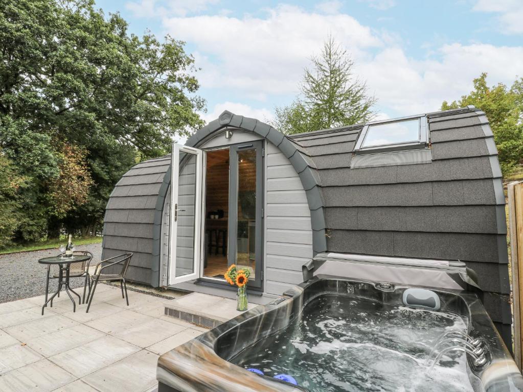 a small shed with a hot tub in it at Oak View in Rhayader