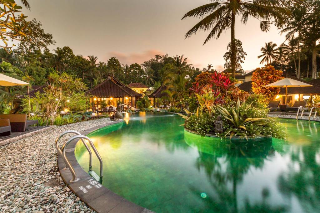 a swimming pool at a resort at night at Villa Taman di Blayu by AGATA in Tabanan