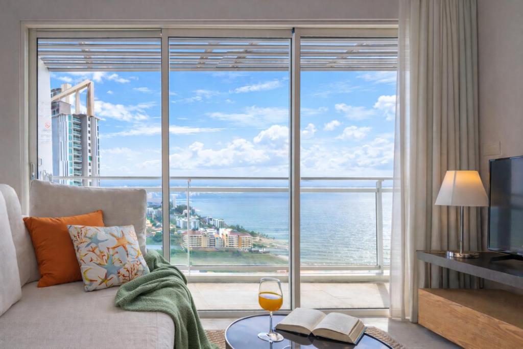 a living room with a view of the ocean at KingBed Beachfront-Pool Condo & Kitchen,Playground,TV,Wifi in Jomtien Beach