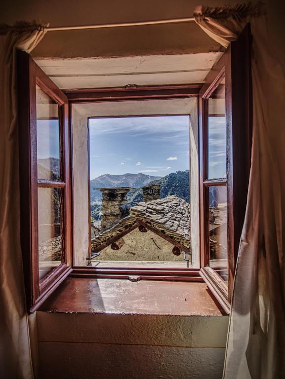 an open window with a view of a mountain at Stones and Pines in Rimella