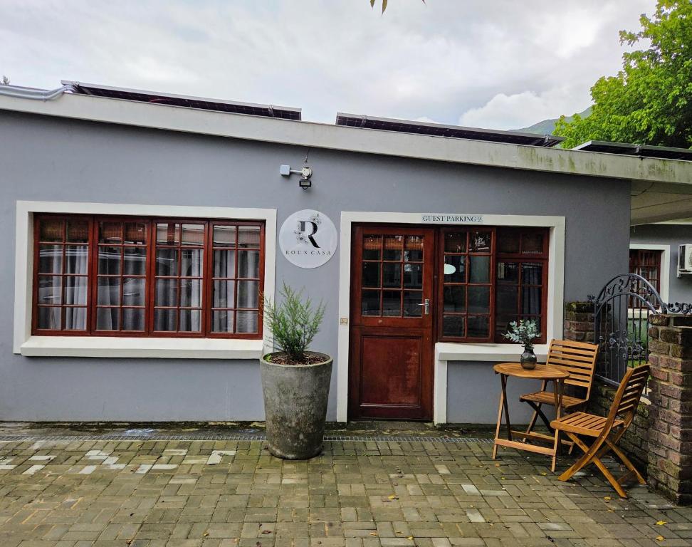 a building with a table and chairs in front of it at Roux Casa 2 in Swellendam