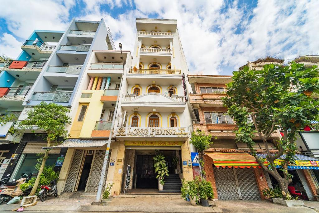 a tall building with a balcony on top of it at Collection O Long Phung Hotel in Ho Chi Minh City